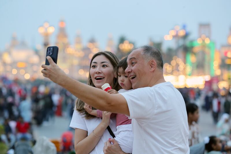 Visitors take selfies for New Years Eve at Global Village, Dubai. Chris Whiteoak / The National