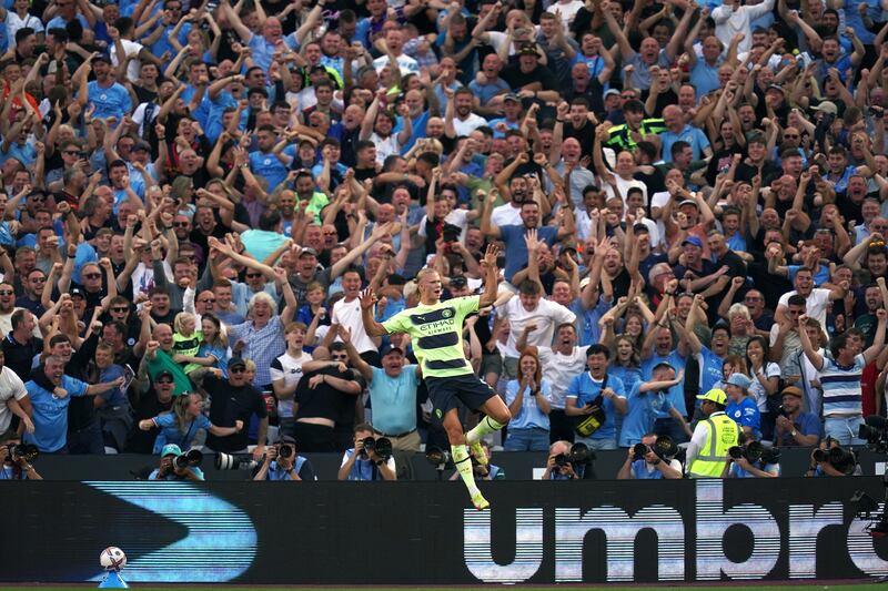 Haaland celebrates with City fans. PA