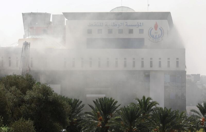 Smoke rises form the headquarters of Libyan state oil firm. Reuters