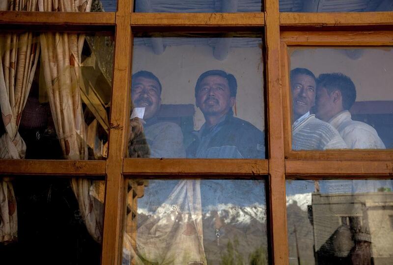 Ladkahis wait inside a polling station to vote near the Thiksey Monastery.