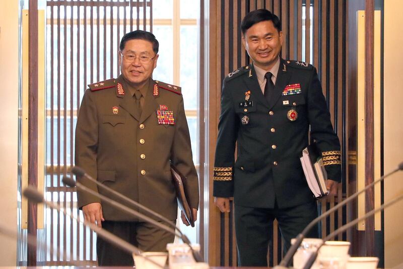 A handout photo made available by the South Korean Ministry of National Defense shows South Korea's chief delegate Major Gen. Kim Do-gyun (R) and his North Korean counterpart Lt. Gen. An Ik-san (L) arriving for the high-level inter-Korean military meeting at the Peace House on the southern side of the border truce village Panmunjom in Paju, South Korea.  EPA / MINISTRY OF NATIONAL DEFENSE