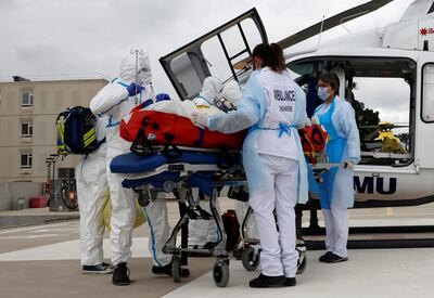 FILE PHOTO: A medical crew from Angers hospital prepares to take away a COVID-19 patient on a stretcher after his transfer by helicopter from the Ile de France region to Angers hospital, France, March 15, 2021. REUTERS/Stephane Mahe/File Photo