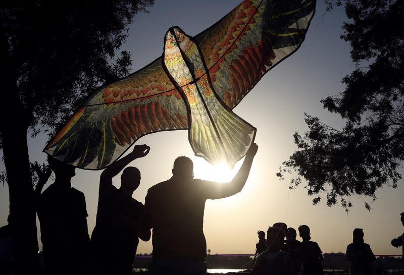 People take part in the annual kite festival in Baghdad, Iraq. AP