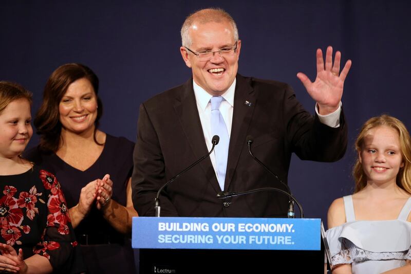 FILE - In this  May 19, 2019, file photo, Australian Prime Minister Scott Morrison, second right, speaks to party supporters flanked by his wife, Jenny, second left, and daughters Lily, right, and Abbey, after his opponent concedes in the federal election in Sydney, Australia. Australiaâ€™s newly reelected administration says its promise to slash income taxes might be delivered late but wonâ€™t be broken as the government hopes to stimulate consumer spending and revive a flagging economy. (AP Photo/Rick Rycroft, File)