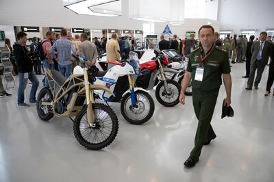 New "Izh Pulsar" electric motorcycles are on display presented by the Concern Kalashnikov during the International Military Technical Forum Army-2018 in Alabino, outside Moscow, Tuesday, Aug. 21, 2018. Russia has displayed its latest weapons at a military show aimed at attracting more foreign customers. (AP Photo/Pavel Golovkin)