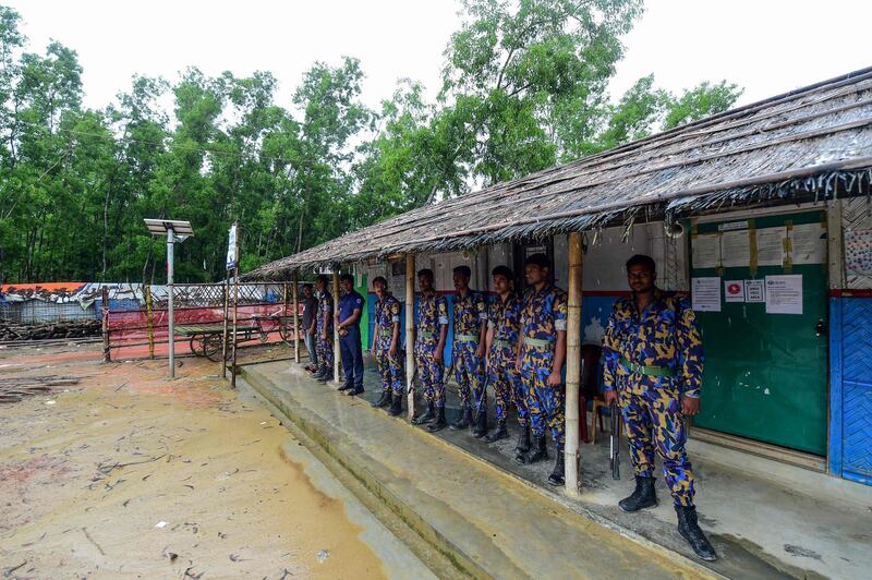 Security personnel stand guard at Jadimura refugee camp in Teknaf on August 24, 2019, following a gunfight between Bangladesh police and Rohingya refugees. Bangladesh police shot dead two Rohingya refugees in a gunfight on August 24 after they were accused of killing a ruling party official in a refugee camp, police said. / AFP / Munir UZ ZAMAN
