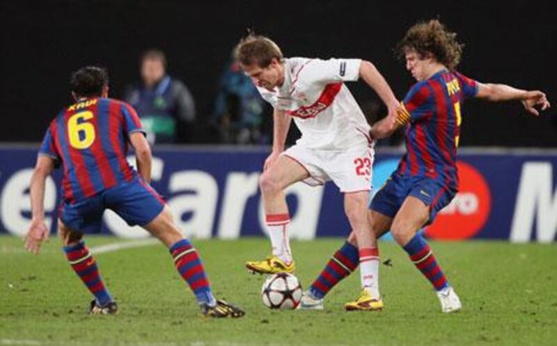 Aleksandr Hleb takes on his former teammates, Xavi, left, and Carles Puyol, right, during the first leg between Stuttgart and Barcelona.
