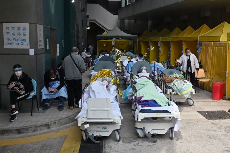 People lie in hospital beds outside Caritas Medical Centre in Hong Kong as the city faces its worst coronavirus wave to date. AFP