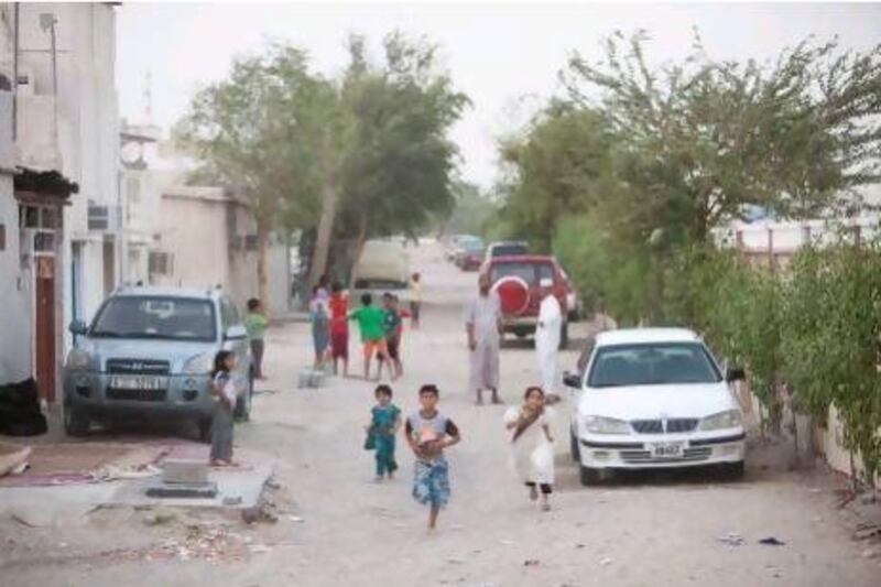 Children play in Sha’biyat Al Shorta, a densely populated neighbourhood in the Dubai-Sharjah border area. This dusty compound of aging homes is threatened with demolition, to the anger of residents, who say that while their community might not look like much, it is safe and boasts a family environment that modern developments lack. A local academic agrees, saying their lives should shape their surroundings.