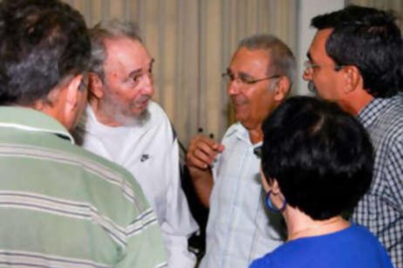 Former Cuban leader Fidel Castro meets workers of the National Centre for Scientific Investigation (CNIC) in Havana on July 7, 2010.