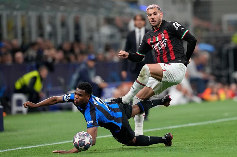 Inter Milan's Denzel Dumfries is challenged by AC Milan's Theo Hernandez. AP