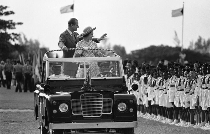 Britain's Queen Elizabeth II and Prince Philip wave to people at Nassau's Clifford Park after their arrival in Nassau, Bahamas, in 1977. AP Photo