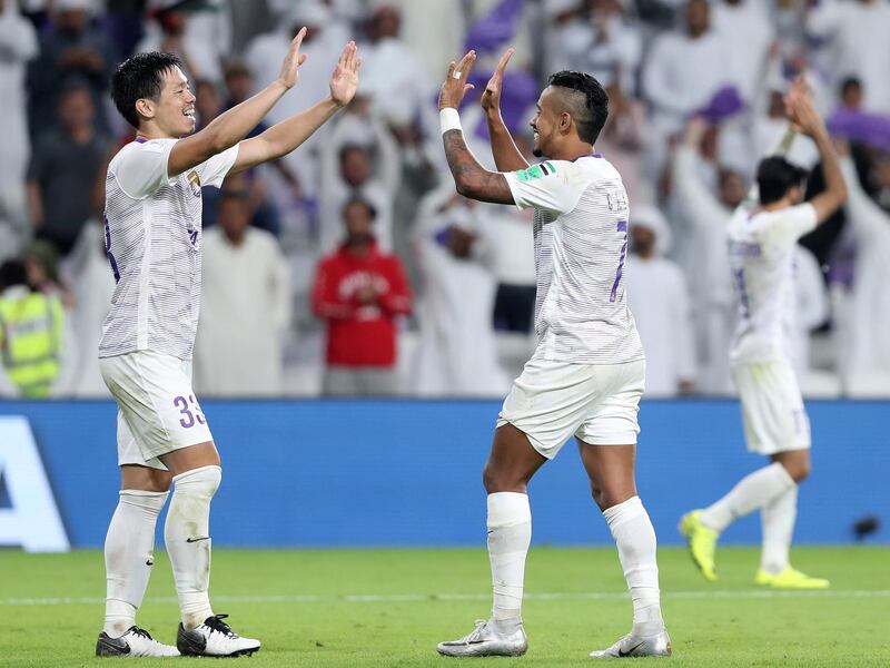 Al Ain, United Arab Emirates - December 12, 2018: Al Ain's Caio (R) and Tsukasa Shiotani celebrate winning on penalties 4-3 after the game between Al Ain and Team Wellington in the Fifa Club World Cup. Wednesday the 12th of December 2018 at the Hazza Bin Zayed Stadium, Al Ain. Chris Whiteoak / The National