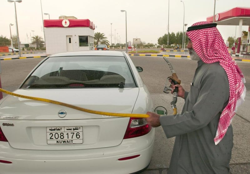 A man refills his car with petrol in Kuwait City, back in 2003. Eric Feferberg/AFP Photo 