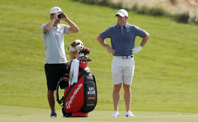 Rory McIlroy with caddy Harry Diamond during a practice round at Yas Links Golf Course. Getty