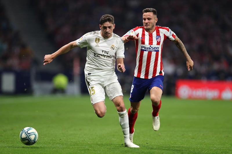 MADRID, SPAIN - SEPTEMBER 28: Federico Valverde of Real Madrid battles for the ball with Saul of Atletico Madrid during the Liga match between Club Atletico de Madrid and Real Madrid CF at Wanda Metropolitano on September 28, 2019 in Madrid, Spain. (Photo by Angel Martinez/Getty Images)