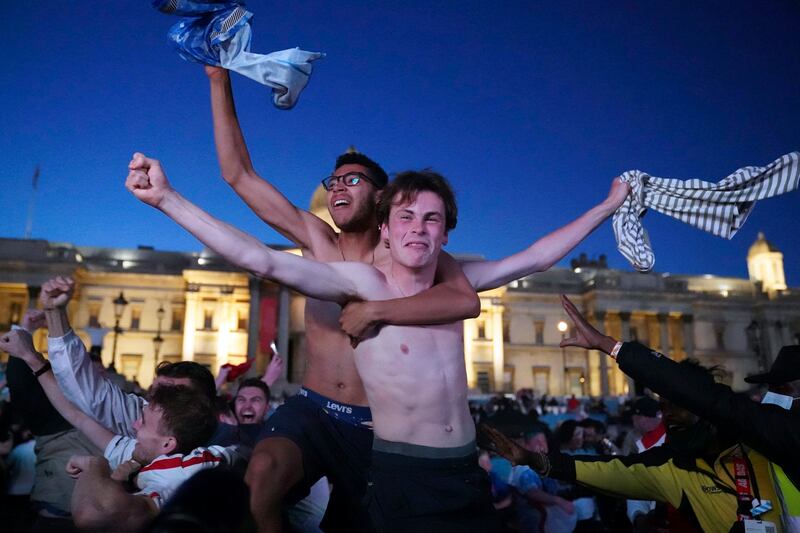 Fans in Trafalgar Square celebrate England's second goal, scored by Harry Kane.