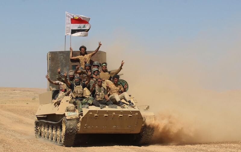 Fighters from the Hashed al-Shaabi (Popular Mobilisation) paramilitaries advance towards the city of Tal Afar, the main remaining stronghold of the Islamic State group, after the government announced the beginning of an operation to retake it from the jihadists, on August 20, 2017.
Iraqi forces pounded the Islamic State group in Tal Afar in a new assault just weeks after ousting IS from second city Mosul. Once a key IS supply hub between Mosul -- around 70 kilometres (45 miles) further east -- and the Syrian border, Tal Afar is the last major population centre in northern Iraq under jihadist control.
 / AFP PHOTO / AHMAD AL-RUBAYE