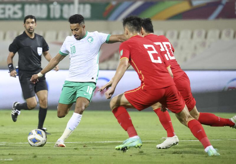 Saudi Arabia midfielder Salem Al Dawsari is closed down by China's Zheng Zheng and Zhu Chenjie. AFP