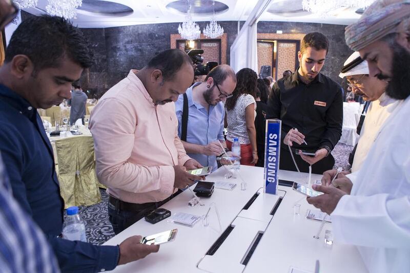 Visitors try the Samsung S6 Edge 6 Plus during the smartphone's launch in Dubai on Tuesday, August 18. Antonie Robertson / The National