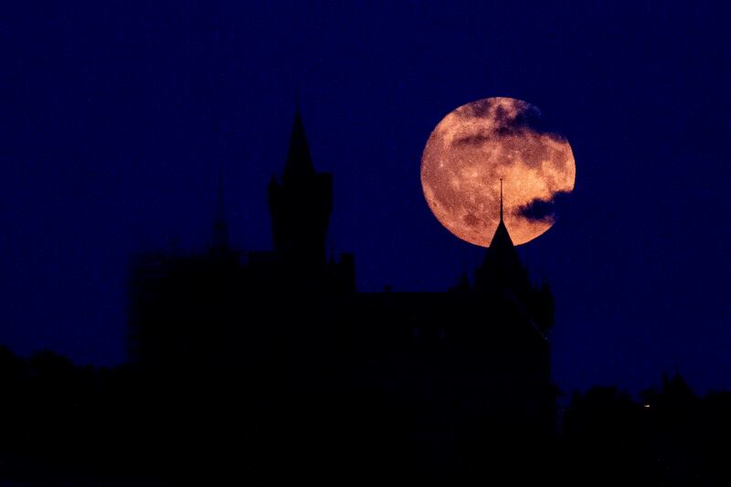 The moon rises behind the castle of Wernigerode near the 'Harz' Mountains, Germany. AP