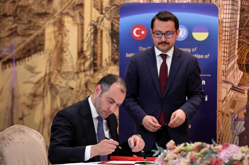 Ukrainian Infrastructure Minister Oleksandr Kubrakov, seated, at the signing ceremony. Reuters