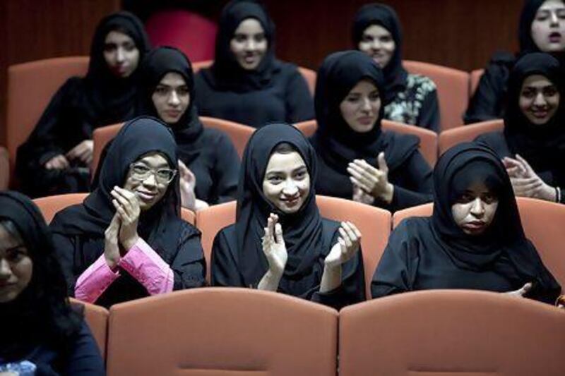 Khalifa University students, L-R, Sara Bani Hashem, 20, a civil engineering student, her sister Yusra Bani Hashem, 19, foundations student who plans to enter biomedical engineering, and Salma al Jaberi, 21, a biomedical engineering student, applaud a presentation during Akoun Workshop, an initiative that aims at inspiring local youth into entering the world of entrepreneurship on March 20 at the Khalifa University of Science, Technology and Research in Abu Dhabi.Silvia Razgova / The National