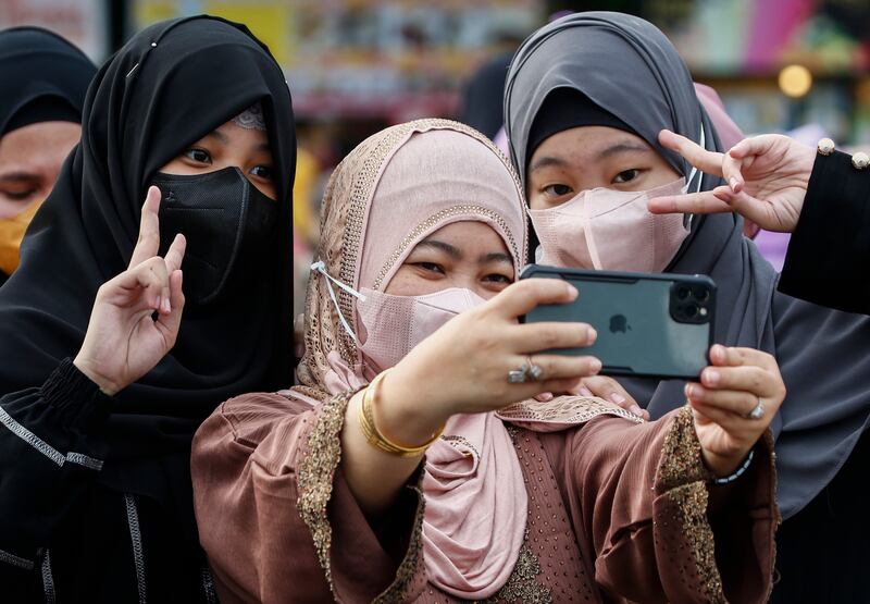 Worshippers in the Philippines take selfies after morning prayers to celebrate Eid Al Adha. PA 