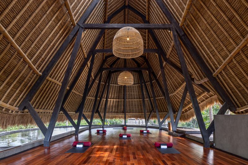 The on-site yoga shala is surrounded by a water feature