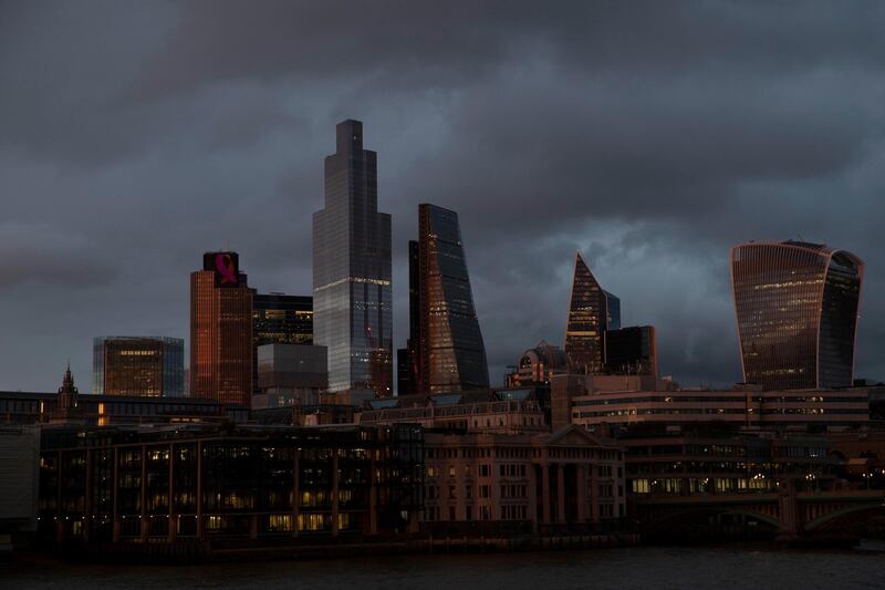 FILE - In this file photo dated Friday, Oct. 23, 2020, the buildings of the City of London stand under a lowering sky, seen from the south bank of the River Thames in London. The Office for National Statistics said Thursday Nov. 12, 2020, that the British economy bounced back strongly in the third quarter of 2020 as many of the restrictions associated with the spring coronavirus lockdown were lifted. (AP Photo/Alastair Grant, FILE)