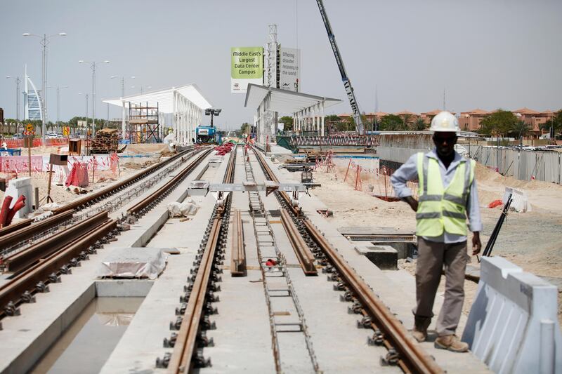 Dubai, April 23 2013 - Workers lay rail and build a station near Dubai Media City for the upcoming Al Safouh Tram Project in Dubai, April 23, 2013. (Photo by: Sarah Dea/The National)

