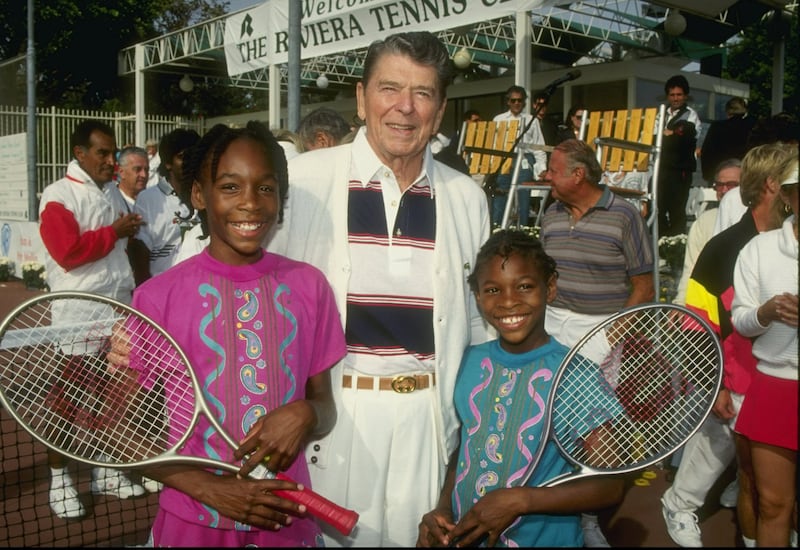 Venus and Serena Williams, wearing a green T-shirt, with former president Ronald Reagan at a tennis camp in Florida in 1990. AFP