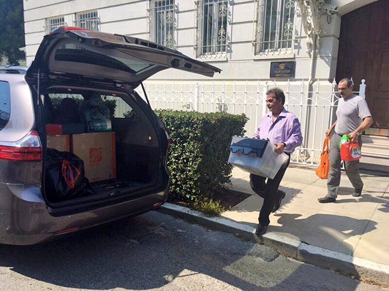 Workers carry boxes out of the Russian consulate in San Francisco as acrid, black smoke was seen pouring from a chimney at the stately building in a historic area of the city Friday, Sept. 1, 2017, a day after the Trump administration ordered its closure amid escalating tensions between the United States and Russia. The workers were hurrying to shut Russia's oldest consulate in the U.S. ahead of a Saturday deadline. (AP Photo/Garance Burke)