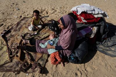 A mother and children shelter in a camp in Rafah. More than 81 per cent of Gaza's population has been internally displaced. Reuters