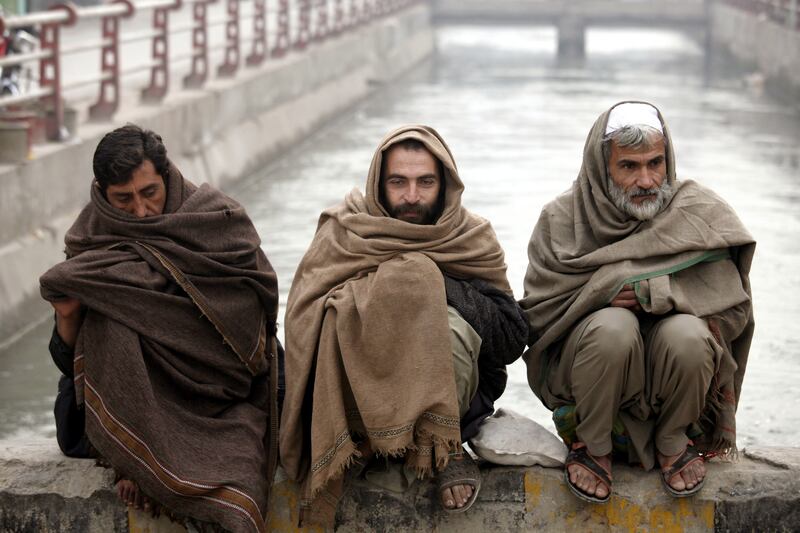 Men shield themselves from the elements in shawls during dense fog and heavy rain in Peshawar, Pakistan. Many cities in the country are experiencing unusually cold conditions of about 5°C during the daytime. EPA