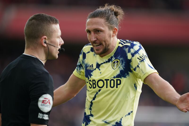 Leeds United's Luke Ayling argues with referee Robert Jones. PA