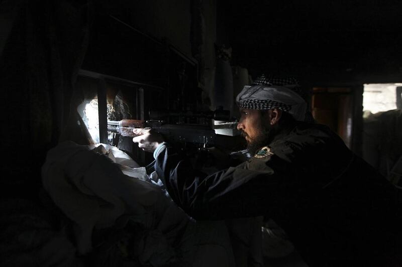 A Syrian rebel takes aim in Deir ez Zor, eastern Syria on February 22, 2014. Khalil Ashawi/Reuters