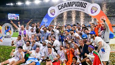 Ain's players celebrate with the winner's trophy after the second leg of the AFC Champions League Final between UAE's Al Ain and Japan's Yokohama F.  Marinos at the Hazza Bin Zayed Stadium in Al-Ain on May 25, 2024.  (Photo by Giuseppe CACACE  /  AFP)
