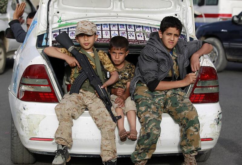 Humanitarian and security experts have said recruitment of child soldiers, such as these Yemeni children photographed this year during a pro-Houthi march in Sanaa, is on the increase. Mohammed Huwais / AFP