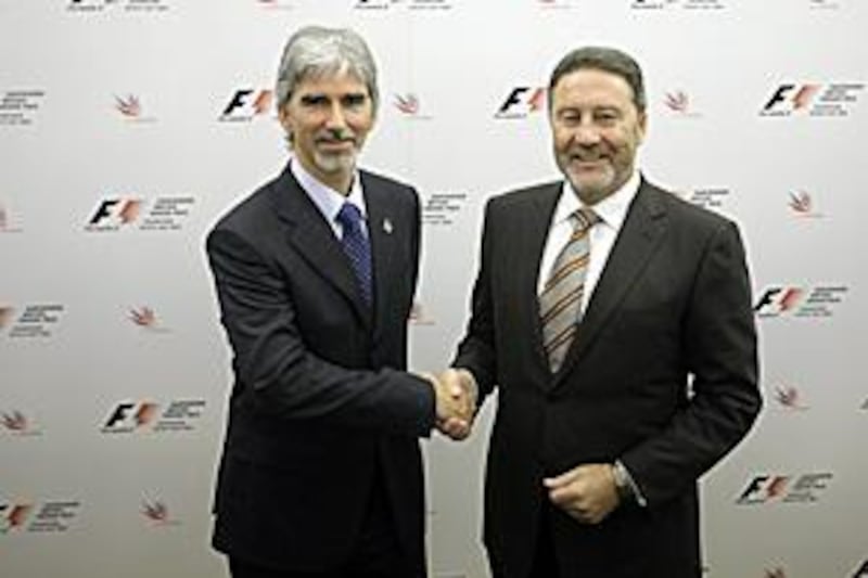 British Racing Drivers Club President Damon Hill, left, shakes hands with the Managing Director of the Silverstone race circuit Richard Phillips after announcing Silverstone will host the British Grand Prix for the next 17 years.