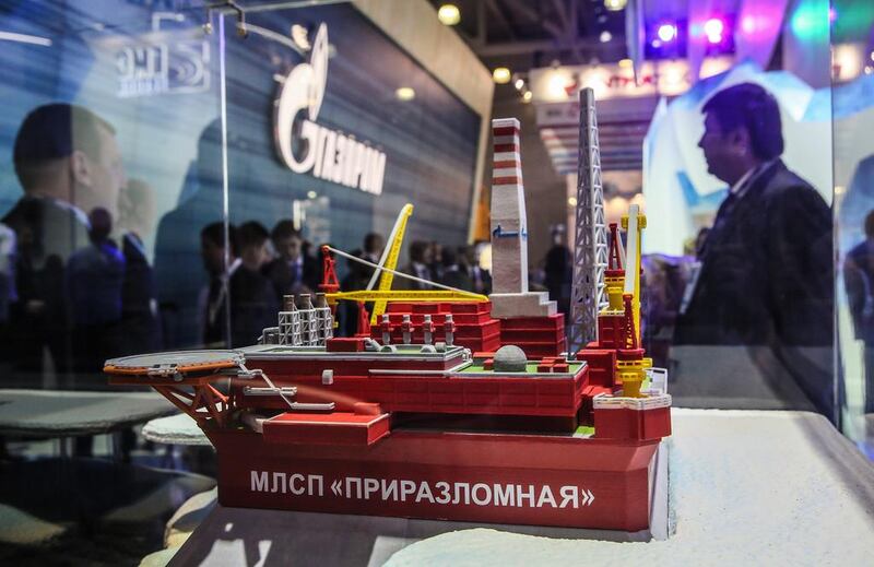 Visitors examine a model of Gazprom Neft's Prirazlomnaya offshore ice-resistant oil-producing platform at the 21st World Petroleum Congress in Moscow. Sergei Ilnitsky / EPA