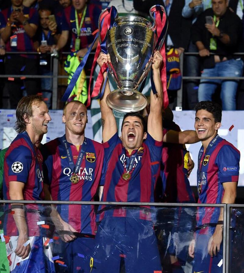 FC Barcelona's players celebrate with the trophy after winning the UEFA Champions League final against Juventus FC on Saturday.  EPA