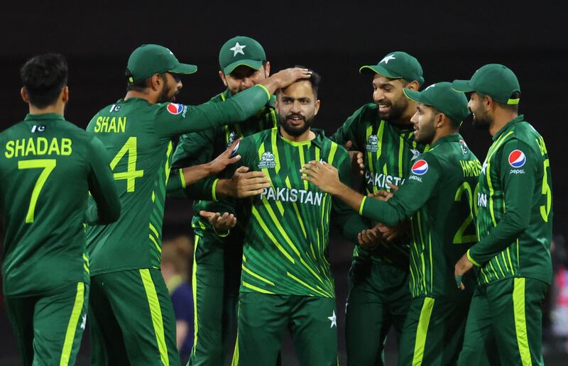 Pakistan's Mohammad Nawaz is congratulated by teammates after his dismissal of New Zealand batter Glenn Phillips for six. AFP