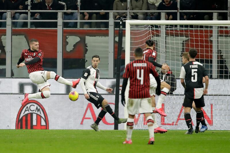 Milan's Ante Rebic, left, scores against Juve. AP