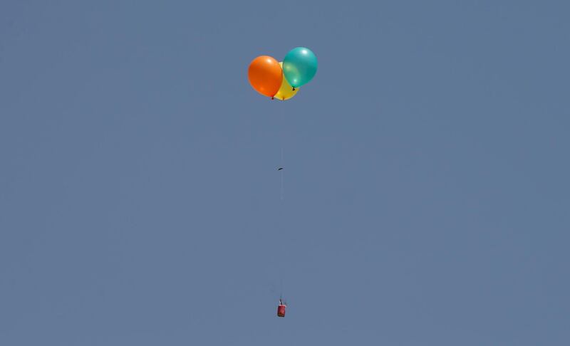 Flaming balloons are released by Palestinian demonstrators.  Mohammed Salem / Reuters