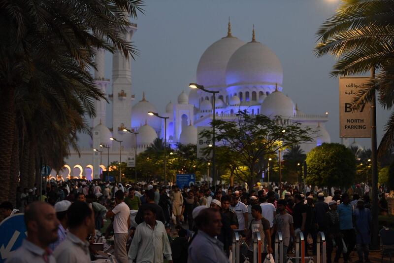 Visitors gather in the courtyard of Abu Dhabi's Sheikh Zayed Grand Mosque on the last Friday of Ramadan. Karim Sahib / AFP