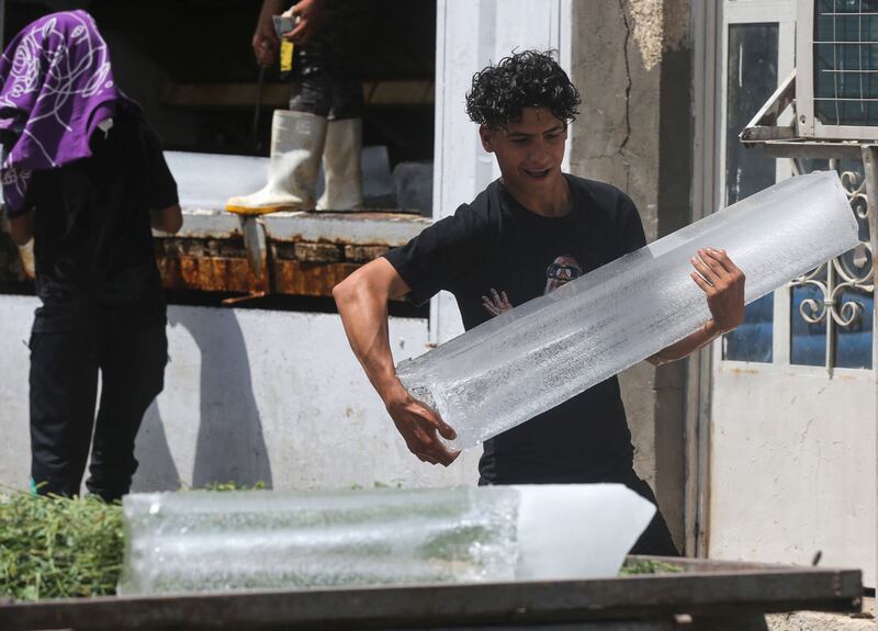 Iraqi youths buy ice blocks at a factory in Sadr City, east of the capital Baghdad, amid power outages and soaring temperatures.