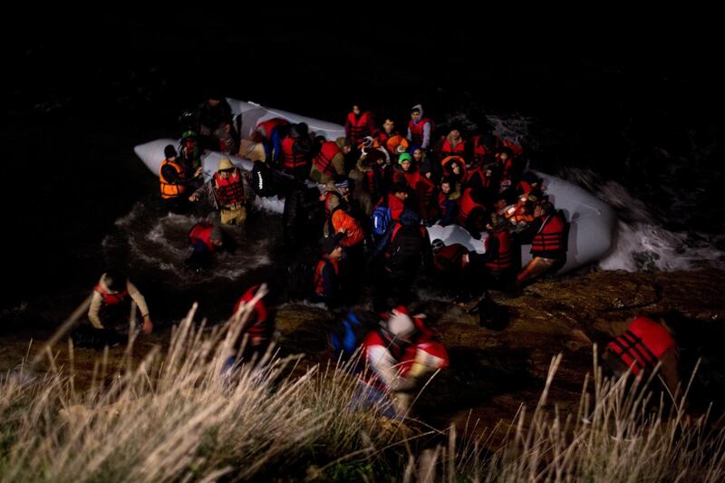 FILE - In this Wednesday, Jan. 20, 2016 file photo, Afghan refugees disembark from a dinghy after crossing a part of the Aegean sea from Turkish coast to the Greek island of Chios. Human rights lawyers on Tuesday, Feb. 16, 2021 have called on Frontex, the European Border and Coast Guard Agency, to immediately stop its activities in the Aegean Sea and formally accused the agency of violating the rights of migrants to seek asylum, as well as other breaches of EU and international law. (AP Photo/Petros Giannakouris, File)