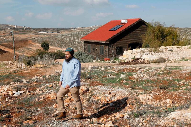 Nati Rom, the founder of Israel's Lev Haolam organization which is active against the Palestnian-led boycott movement, walks next to an Airbnb apartment located in the Esh Kodesh outpost near the Jewish settlemtn of Shilo in the occupied West Bank on November 20, 2018.  Human Rights Watch urged Booking.com to follow the example of Airbnb and withdraw listings for rentals located in settlements in the Israeli-occupied West Bank.
Airbnb said earlier in the week that it will remove such listings, just ahead of the release of an HRW report criticising them.
 / AFP / afp / MENAHEM KAHANA
