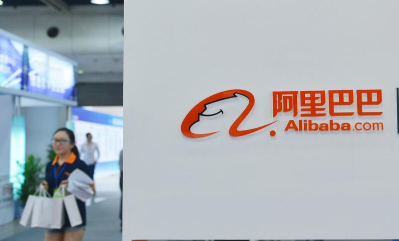 (FILES) This file picture taken on September 9, 2014 shows a woman walking past the Alibaba booth during an exhibition in Hangzhou, east China's Zhejiang province.
Chinese e-commerce giant Alibaba said April 2, 2018 it was acquiring full ownership of leading food-delivery firm Ele.me in a deal that values the Shanghai-based start-up at $9.5 billion. / AFP PHOTO / STR / China OUT
